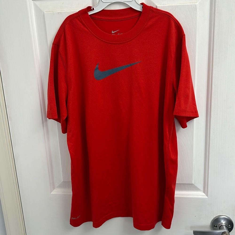 Boys Nike dri-fit tshirt size large. Red tshirt with a blue/gray Nike swoosh